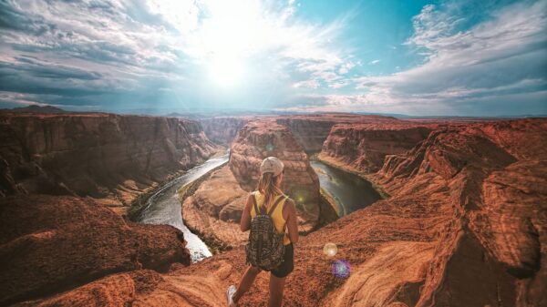 woman standing on top of canyon